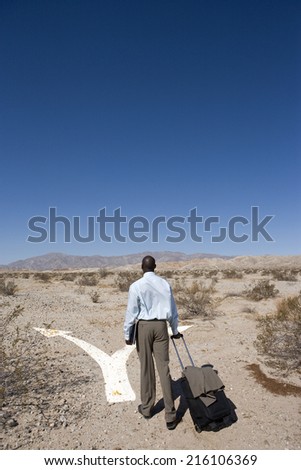 Businessman walking through desert