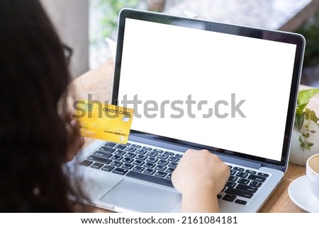 Close-up of freelance people business female Hand holding Credit cards casual working using with laptop computer with coffee cup in coffee shop like the background,Online payment shopping concept