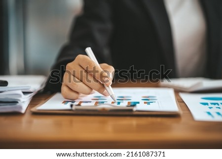 Business women are looking at the company's financial documents to analyze problems and find solutions before bringing the information to a meeting with a partner. Financial concept.