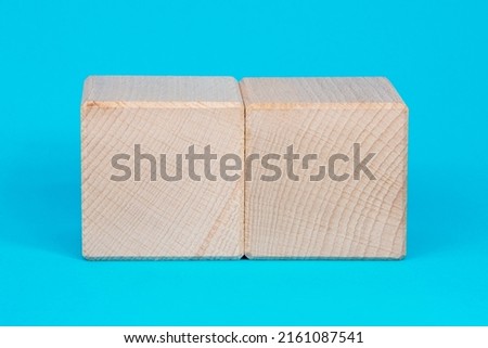 Empty clear wooden cube on blue background