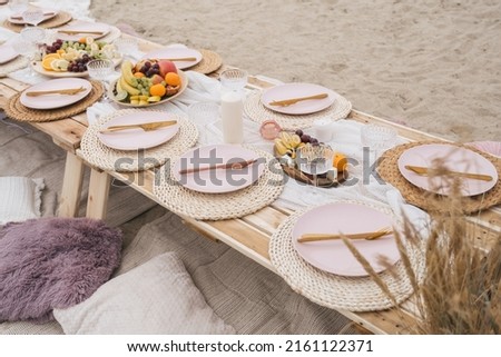 Bachelorette party on a beach. Boho style design picnic outdoor. Decorations for celebration birthday, party, friends.  Royalty-Free Stock Photo #2161122371