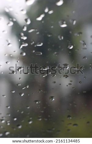 water falling on glass on a blurry background