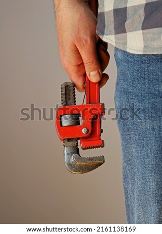 hand of a man holding a wrench
