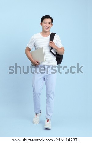 Asian handsome and cheerful young student man, isolated on background