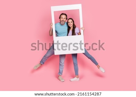Full body photo of two cheerful excited carefree people look camera album card isolated on pink color background