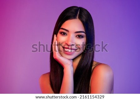 Photo of charming nice young woman hold hand face use hydration product smile isolated on abstract background