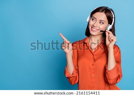 Portrait of attractive trendy cheerful girl help desk service showing copy space isolated over bright blue color background Royalty-Free Stock Photo #2161154411