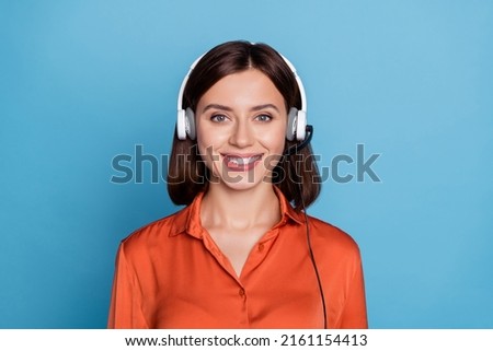 Portrait of attractive cheerful girl help desk operator answering calls isolated over bright blue color background Royalty-Free Stock Photo #2161154413