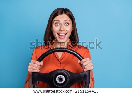 Photo of young excited girl ride automobile vehicle trip speed road isolated over blue color background