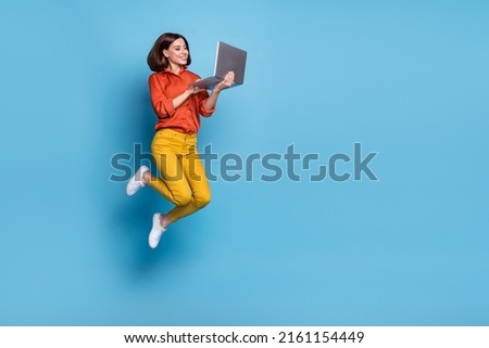 Full body profile side photo of young lady type laptop workshop marketer jumper isolated over blue color background