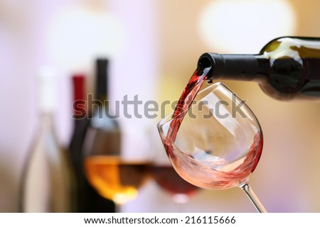 Red wine pouring into wine glass, close-up Royalty-Free Stock Photo #216115666