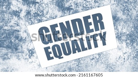 Gender Equality words on card on wooden table. Equal rights social concept.