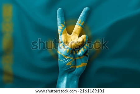 Hand making the V victory sign with flag of kazakhstan
