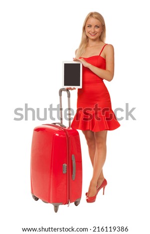 blonde girl wearing red dress holding tablet with big suitcase isolated on white background