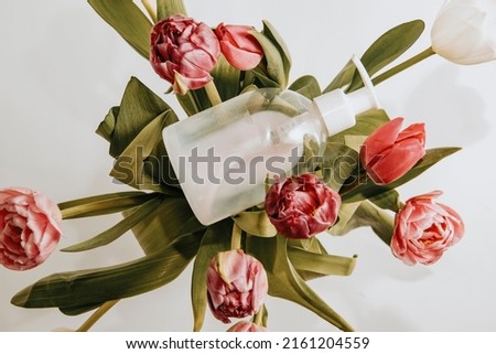 A bottle in a bouquet of flowers