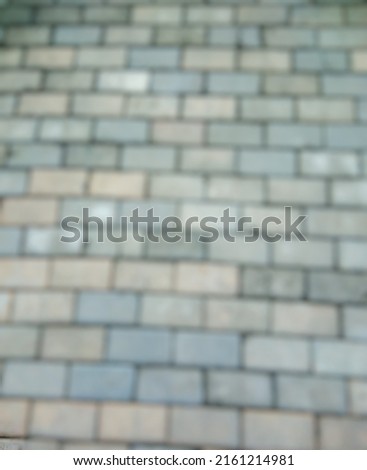 defocused pictures of grey brickstones on the street. good for construction wallpaper, banner, etc.