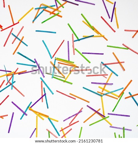 Wallpaper made of colorful sticks, red, blue, green, yellow, purple, orange, on clear white background. Minimal texture concept. Colors eliminate depression. Diversity out of order.