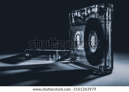 Old audio cassette on a black background. Black and white photo.  Royalty-Free Stock Photo #2161263979