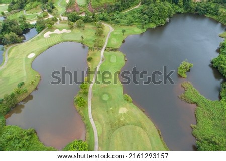 Aerial view drone shot of beautiful green golf field fairway and putting green Top down image for sport background and travel nature background Amazing view