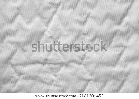 Close up of a white cotton incontinence pad texture background.