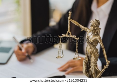 Lady of justitia with lawyer woman working with contract.