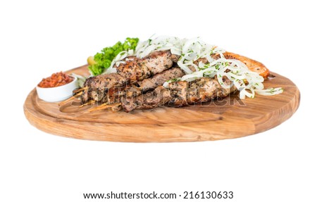 Healthy barbecued lean cubed pork kebabs served with a corn tortilla and fresh lettuce and tomato salad