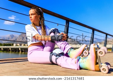 Protective skate safety concept , woman with equipment in beach and mountain background on a summer day