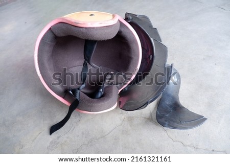 Broken helmet lying on the floor Royalty-Free Stock Photo #2161321161
