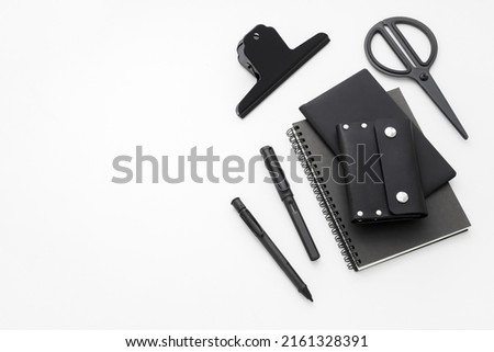 Stationery isolated on white background. Black colour. Pen, Pencil, Note book, Card holder, Black metal paper clip. Minimalist style. Men's Lifestyle. Stationery Design. Space for text.