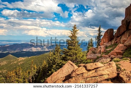 Clouds over red rocks landscape. Mountain gill valley rocks under sky clouds. Mountain rocks on cloudy sky background. Mountain rocks landscape Royalty-Free Stock Photo #2161337257