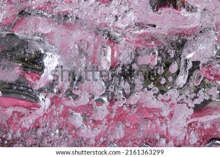 Ice is a delicate pink color with air bubbles inside.