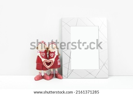 Silvery frame with a toy on a white background. Frame mockup for your design.