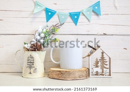 Mockup of a white ceramic mug with blue flags. White coffee mug on the table. Festive mockup.