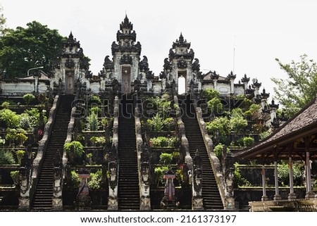 Majestic balinese culture Lempuyang temple in Bali - high stairs and sacred gate with towers decorated statues carved of stone and lush garden. Famous landmark of hindu, balinese, buddhism religion. Royalty-Free Stock Photo #2161373197