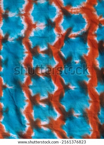 blue cloth with orange and brown motifs