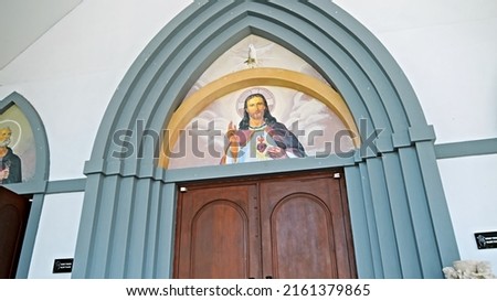 Picture of Jesus in the top of the door to the church on the entrance