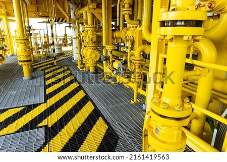 Walking on walkway Metal grating on the Wellhead Platform of Oil  Gas in the offshore with safety sign colors.