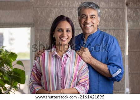 Happy mature couple spending leisure time together at home