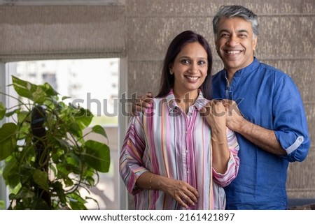 Happy mature couple spending leisure time together at home Royalty-Free Stock Photo #2161421897