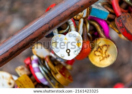 Wedding lock in soft focus as a symbol of love, tenderness, romance, eternity and endless love for lovers. Padlocks are attached to the bridge railing to celebrate the wedding, love locks.