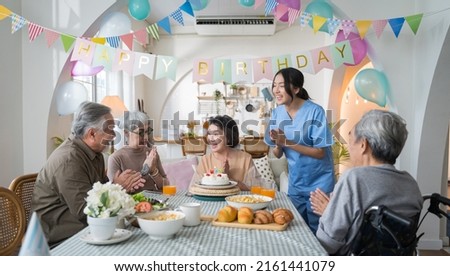 Group of Asian senior people having birthday party at home, celebrating birthday at retirement home with friends