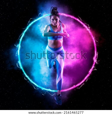 Sporty young woman running on fire background