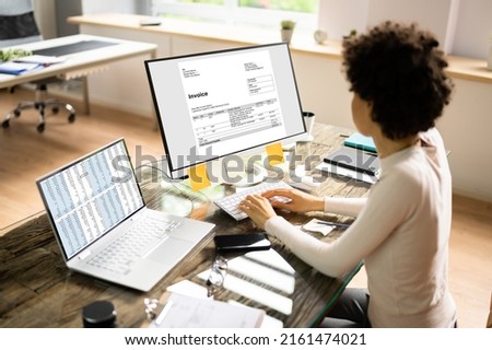 Accountant Using E Invoice Software At Computer In Office Royalty-Free Stock Photo #2161474021