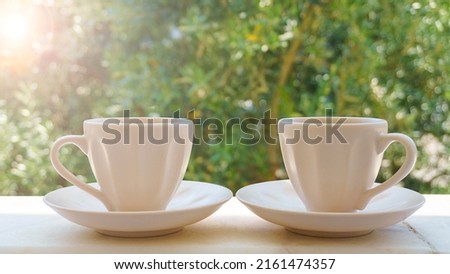 Two cup of coffee or brewed Turkish tea on green nature background. Drinking coffee to start a day positive mood or stay awake, sleepless. Coffee (espresso, americano etc.) addiction concept. Royalty-Free Stock Photo #2161474357