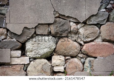 Close-up partial view of an old deteriorating stone wall