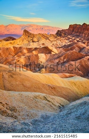 Iconic sunrise colorful waves at Zabriskie Point in Death Valley National Park Royalty-Free Stock Photo #2161515485