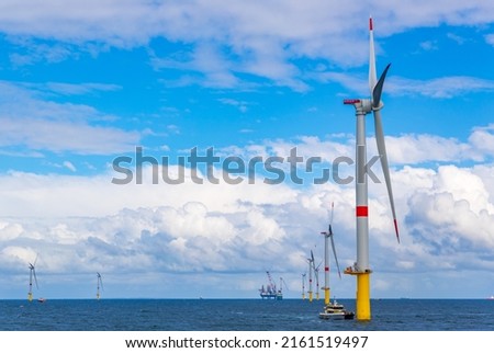 Offshore wind turbines generating power Royalty-Free Stock Photo #2161519497