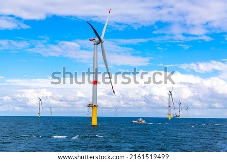 Offshore wind turbines generating power Royalty-Free Stock Photo #2161519499