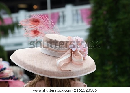Elegant hats at a horse race  Royalty-Free Stock Photo #2161523305