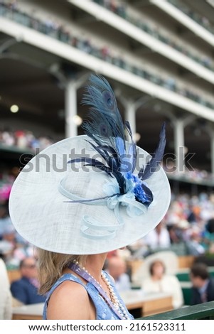 Elegant hats at a horse race  Royalty-Free Stock Photo #2161523311